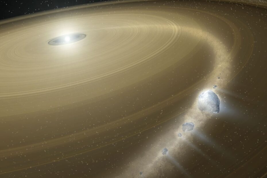 Este conceito artístico mostra uma anã branca cercada por um grande disco de detritos. Fragmentos de um objeto semelhante a Plutão, que foi capturado, estão caindo sobre a anã branca.