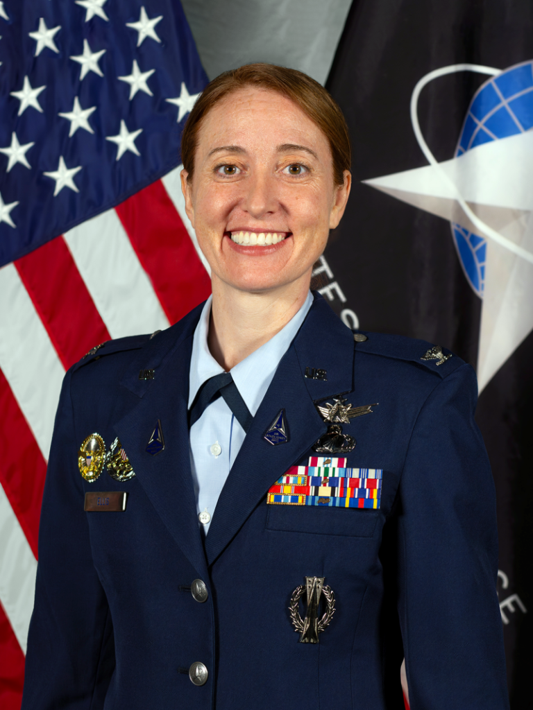 Ellen Ellis, from North Kingstown, Rhode Island, is a colonel and an acquisitions officer in the United States Space Force. She currently serves as a senior materiel leader in the National Reconnaissance Office (NRO) Communications Systems Directorate. She is responsible for fielding commercial cloud and traditional information technology hosting solutions and building modernized data centers for the NRO. She previously served as an Intercontinental Ballistic Missile operations officer and GPS satellite engineer, and she also developed geospatial intelligence payloads and ground processing systems.  