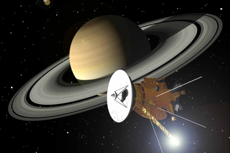 Impressão artística da nave Cassini-Huygens (NASA/ESA/ASI) orbitando Saturno e seus magníficos anéis. O brilho de luz atrás da haste do magnetômetro, na parte inferior da espaçonave, é um reflexo do Sol.