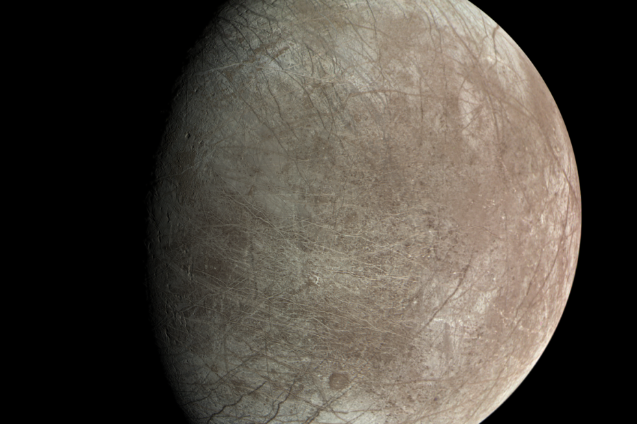 Lua Europa de Júpiter fotografada pela sonda Juno durante sobrevoo em 29 de setembro de 2022, mostrando fraturas, cristas e faixas que cortam a superfície gelada.