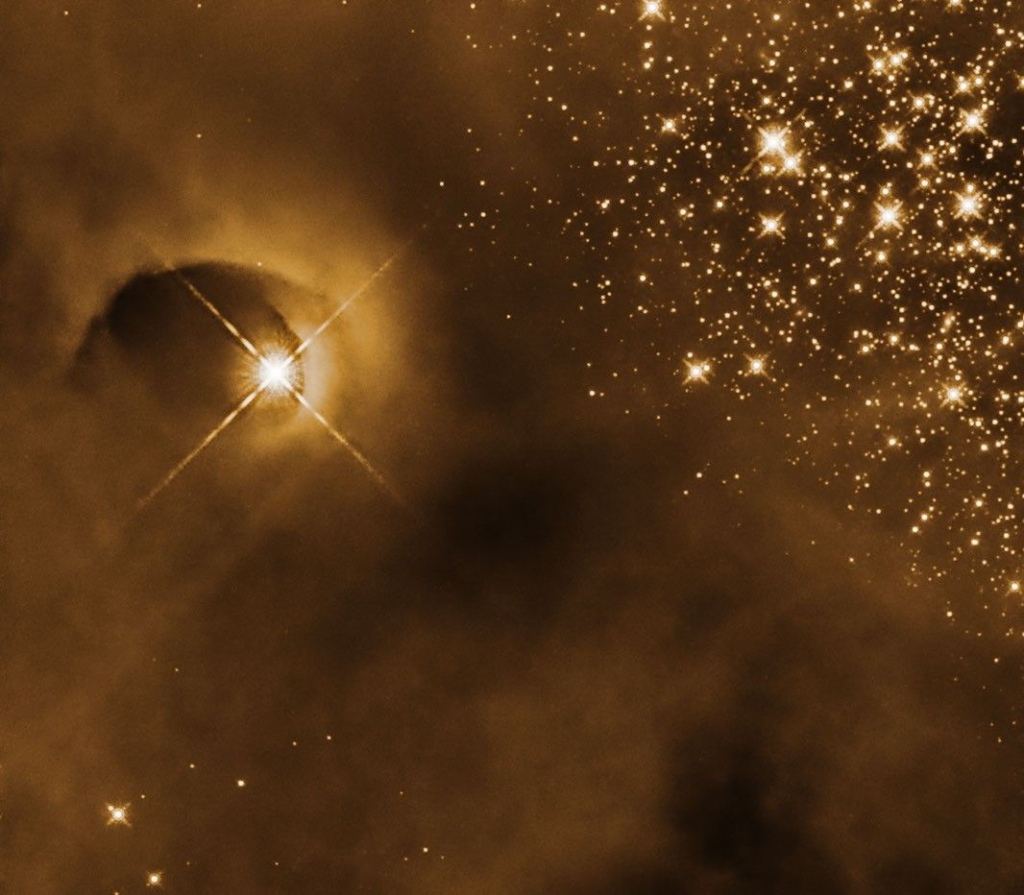 Imagem do Telesc&oacute;pio Espacial Hubble mostra uma cavidade curva esculpida em uma nuvem de g&aacute;s por uma protoestrela, resultado da eje&ccedil;&atilde;o de mat&eacute;ria durante sua forma&ccedil;&atilde;o.