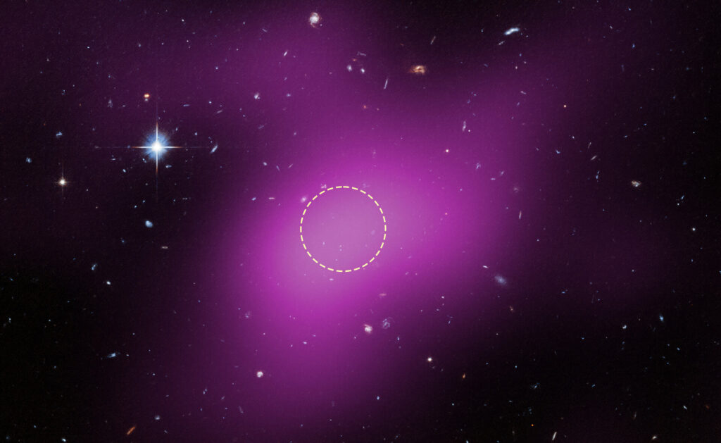 Imagem do espa&ccedil;o profundo mostrando v&aacute;rias gal&aacute;xias ao fundo e uma estrela brilhante no canto superior esquerdo. Uma grande regi&atilde;o difusa em tom magenta ocupa boa parte da imagem, representando dados de r&aacute;dio que indicam a presen&ccedil;a da Cloud-9. Um c&iacute;rculo tracejado branco destaca a &aacute;rea de maior emiss&atilde;o de r&aacute;dio, onde astr&ocirc;nomos procuraram estrelas, mas nenhuma foi encontrada.