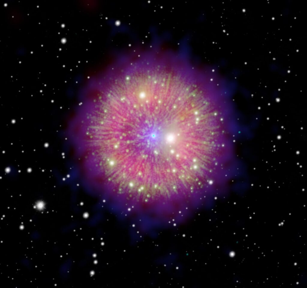 Remanescente da supernova Pa 30 na constela&ccedil;&atilde;o de Cassiopeia, mostrando filamentos coloridos ao redor de uma estrela central, em uma imagem composta que combina dados em raios X, &oacute;ptico e infravermelho de v&aacute;rios telesc&oacute;pios.