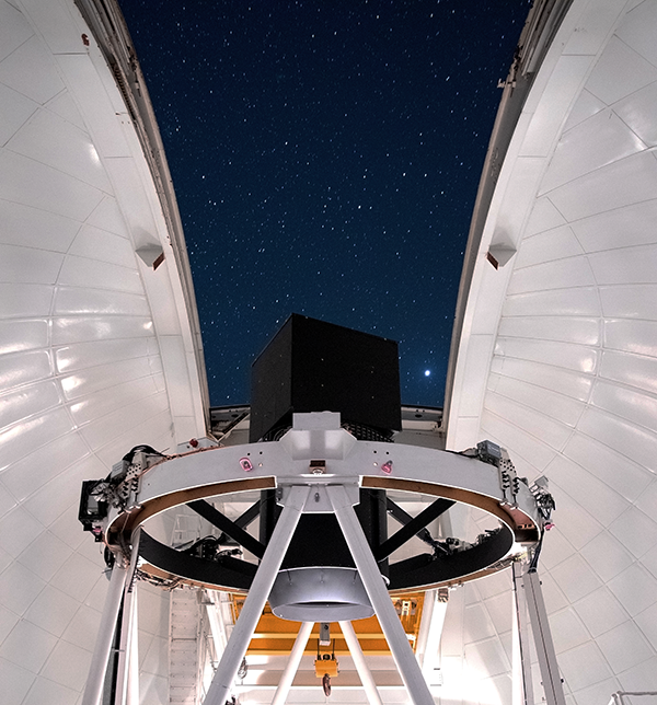 WHT, with WEAVE at top end, photo by Kane Sjoberg, Sep 2023)
A powerful new fibre-fed multi-object spectrograph, WEAVE, has been mounted at the prime focus of the WHT. The large-integral-field (LIFU) mode has been commissioned, and dedicated science surveys in this mode began in 2023. Commissioning of the multi-object (MOS) functionality is ongoing, and the MOS science surveys are expected to start in autumn 2025.

Once WEAVE is commissioned, 70% of the time on the telescope will be used to carry out the dedicated surveys with WEAVE. The remaining 30% of the time is open time, available to the community. During 2025 and 2026, open-time observations will be carried out with WEAVE only, and observations with older instruments (e.g. ISIS, ACAM) or visiting instruments will not be possible during this period.

The application procedure for WEAVE open time (including target-of-opportunity) is documented here.

The median seeing at the WHT is 0.8 arcsec during April - November. The dark-of-moon sky brightness at high ecliptic latitude is similar to that at other good dark sites, V ~ 21.9 mag arcsec2.